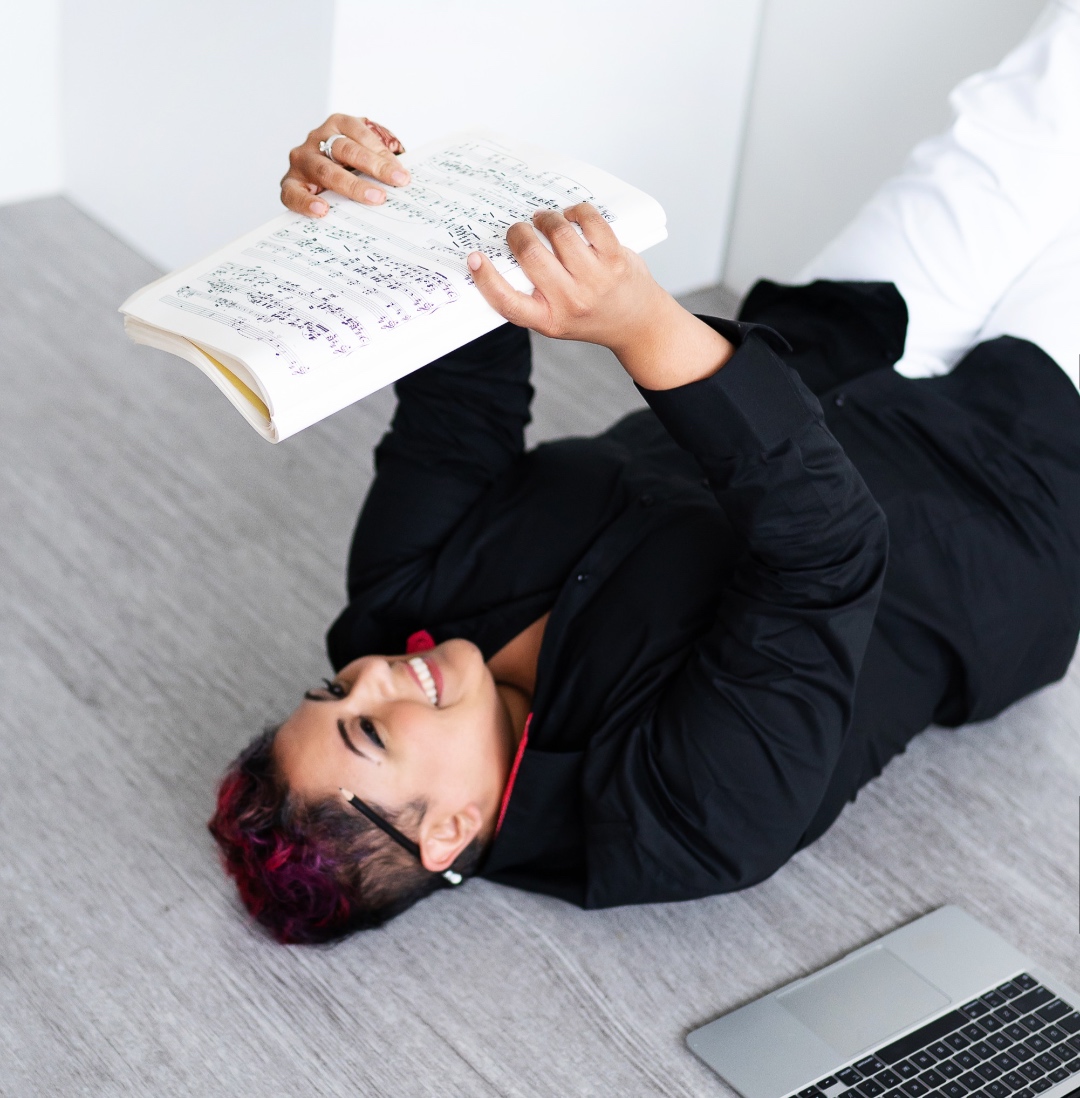 Farah lying with sheet music